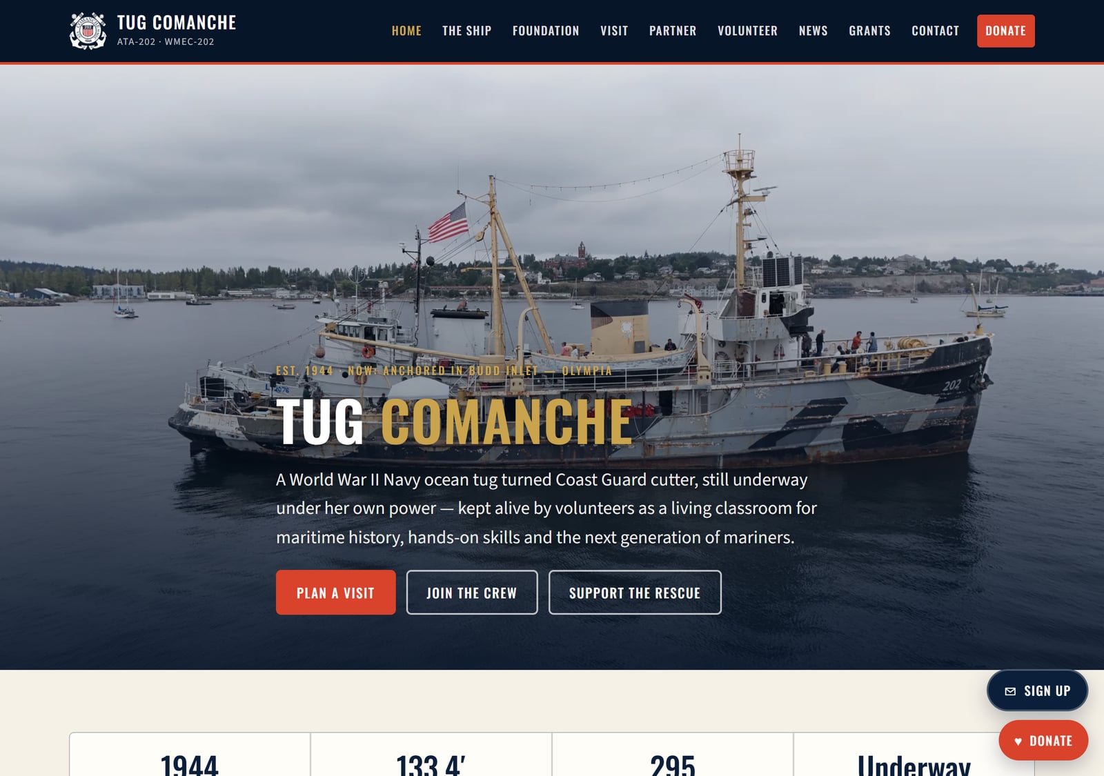 The home page. That's Comanche herself, a 1944 Navy ocean tug, moored in Budd Inlet off Olympia. Drone stills the volunteers shot, a Coast Guard-style crest, and the one thing a rescue site has to get right: a donate button that's never more than a tap away.